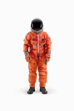 an orange astronaut suit is shown in front of a white background