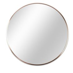 a round mirror on a white wall with a gold rim and an oval metal frame