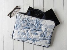 a blue and white toiler bag sitting on top of a table next to glasses