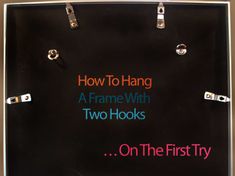 a sign that says how to hang a frame with two hooks on the first try