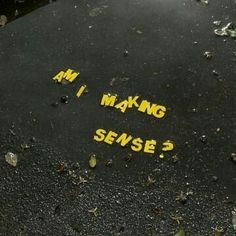 the word m i making sense written in yellow ink on a wet surface