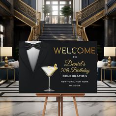 a welcome sign for a 50th birthday party with a martini glass in front of it