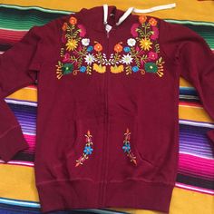 Beautiful Mexican Embroidered Sweatshirts !! Care : Hand Wash Or Dry Cleaning. Fabric: Cotton. Measurements: Small - Medium: Length: 23” Armpit To Armpit: 17” Sleeve Length: 23” Large -Extra Large Length: 26” Armpit To Armpit: 20” Sleeve Length: 24” Fall Hoodie With Embroidered Logo, Red Cotton Hoodie With Embroidered Graphics, Embroidered Graphics Hoodie For Fall, Embroidered Hoodie For Fall, Red Tops With Embroidered Logo For Fall, Casual Red Sweatshirt With Embroidered Graphics, Red Embroidered Tops For Fall, Casual Red Embroidered Sweatshirt, Casual Red Embroidered Sweater