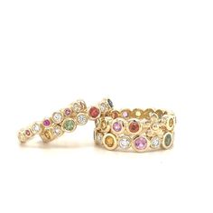 Our beautiful hand-made Primrose band set with Rainbow Sapphires and adorned by a single flower is set in yellow gold! Stack it with our other bands or wear by itself! 14k Yellow Gold Multicolored Sapphires Flower in band Can be worn as an Anniversary Band Size 6 1/2 *Please contact us at info@laurensigmancollection.com to inquire about an alternative size* Each band is unique and may have slight color differences than photos shown If not in stock, allow 4-6 weeks for delivery LS Collection Elegant Multicolor Stackable Jewelry, Multicolor Stackable Fine Jewelry, Elegant Multicolor Rings With Bezel Setting, Fine Jewelry: Multicolor Stackable Pieces, Elegant Multicolor Stackable Rings, Elegant Multicolor Stackable Rings For Wedding, Elegant Multicolor Multi-stone Stackable Rings, Multicolor Multi-stone Stackable Fine Jewelry Rings, Multicolor Multi-stone Stackable Rings In Fine Jewelry Style