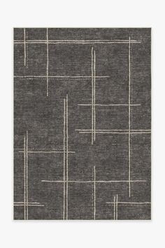 a gray rug with white lines on the top and bottom, in front of a grey background