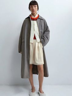 The Cordera Wax Cotton Trench in Taupe Grey is a unique and special rainy trench coat that is light and water repellent. Designed with a relaxed fit and long length, it's a perfect piece for the in-between season. Detailed with covered buttons and two ornamental pockets. 50% cotton / 39% polyester / 16% polyamide Hand wash or dry clean Made in Spain — Cordera, founded by sisters Mónica and María in 2008, has cultivated a distinct identity rooted in minimalism and ethical production practices. Ne Long Single-breasted Fall Raincoat, Fall Long Single-breasted Raincoat, Fall Long Single Breasted Raincoat, Fall Solid Single-breasted Raincoat, Fall Single Breasted Raincoat, Fall Single-breasted Raincoat, Solid Long Raincoat For Fall, Long Solid Color Raincoat For Fall, Long Raincoat For Fall