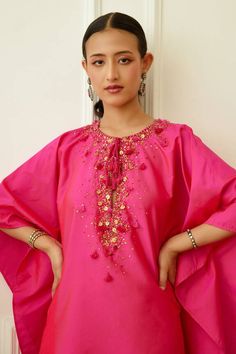 Pink flared kaftan with sequin embellishments on neckline. Comes with drape skirt.
Components: 2
Pattern: Embroidered
Type Of Work: Sequin
Neckline: Keyhole
Sleeve Type: Cape Sleeves
Fabric: Rayon Silk Mix,Viscose Crepe
Color: Pink
Other Details: 
Front drawstring detail
Occasion: Sangeet,Mehendi and Haldi - Aza Fashions Drawstring Detail, Cape Sleeves, Skirt For Women, Skirts Online, Pink Sequin, Aza Fashion, Sleeve Type, Cape, Embellishments