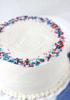 a white cake with red, white and blue sprinkles on the top