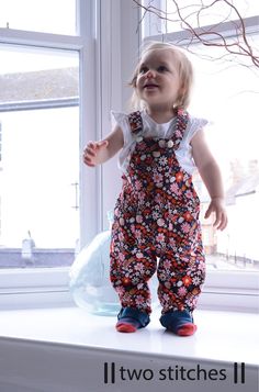 Every kid needs a good pair of dungas, and for babies and toddlers, these might be them! With contrast facing for straps, bibs, and pockets and turn ups, use fun co-ordinating prints to make these dungarees sing. Keeping practicality in mind the pattern features an elasticated back waist, more bum room for nappies, side buttons, and snap fasteners on the inner leg.  Suggested Fabrics: medium weight woven fabrics such as cotton, cotton blends, linen, denim, needlecord, etc.  Notions: 2 x 25-30mm Dungarees Pattern, Dungarees Dress, Dungaree Pattern, Toddler Sewing Patterns, Winter Romper, Cotton Lawn Fabric, Gathered Dress, Teenage Daughters, Paper Sewing Patterns