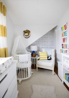 a baby's room with white furniture and yellow curtains