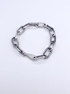 This chain bracelet is made in the style of our plain twist chain necklace. It has an alternating plain round wire link and twist wire link that is certainly going to enhance your style. The finish on the chain has an oxidized finish. It can be a high polished finished upon request. Each link is hand crafted and assembled. Classic Silver Cable Chain Bracelet, Silver Cable Chain Link Bracelet, Silver Oval Link Chain Bracelet With Cable Detail, Silver Chain Bracelet With Hook And Links For Everyday, Silver Cable Chain Bracelet With Oval Links, Sterling Silver Link Bracelet With Silver Chain, Sterling Silver Bracelet With Cable Chain, Silver Cable Chain Sterling Silver Bracelet, Sterling Silver Bracelet With Cable Chain Design