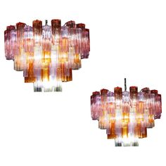 a pair of multi - colored glass chandeliers, designed by muranoni