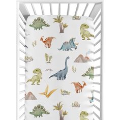 a crib bed with dinosaurs on it