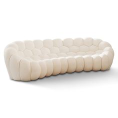 a white couch sitting on top of a white floor