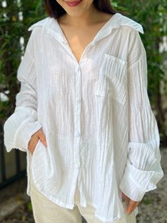 "Introducing the ultimate summer shirt that's perfect for beachwear, as a swimsuit cover, and beyond - the Muslin Double Gauze Long Sleeved Loose Fit Shirt. Made from high-quality double gauze crepe cotton material, this versatile shirt is soft, lightweight, and breathable, making it ideal for hot summer days. Fits Small, Medium and Large Front Length - 29\" Back Length - 30\" Sleeve Length - 23.5\" Bust - 44\" The loose fit design of the shirt allows for maximum comfort and freedom of movement, Relaxed Fit Long Sleeve Top For Beach Cover-up, Summer Beach Button-up Shirt, Beachwear Long Sleeve Relaxed Fit Blouse, Long Sleeve Beachwear Blouse With Relaxed Fit, Relaxed Fit Long Sleeve Beachwear Blouse, Relaxed Long Sleeve Tops For Summer, White Summer Button-up Shirt, White Button-up Summer Shirt, Button-up Beachwear Blouse For Beach Season