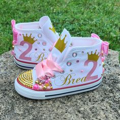 White high top Converse with your child's name and age.  All decor is done in pinks and golds.  Sparkly bows on the backs. Customizable Pink Sneakers As A Gift, Pink Round Toe Sneakers For Birthday, Pink Low-top Sneakers For Birthday, Pink Lace-up Sneakers For Birthday, Converse Gold, Bedazzled Shoes, Custom Sneakers Diy, White High Top Converse, Bling Converse