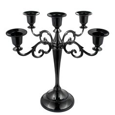 a black candelabra with five candles in it on a white background,