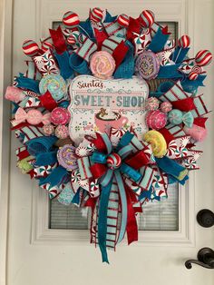 a wreath that is hanging on the front door with candy and candies in it