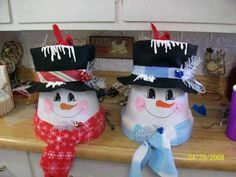 two snowmen sitting on top of a kitchen counter