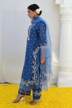 Jean blue kurta features an embroidered organza border on the slits, hemline as well as the sleeves, sprinkled with delicate dori dots all over. Paired with embroidered palazzo and an embroidered organza dupatta.
Components: 3
Pattern: Embroidered
Type Of Work: Floral,Polka Dot
Neckline: Notched
Sleeve Type: Bell Sleeves
Fabric: Banaras Silk Base
Color: Blue
Other Details: 
Front tie-up
Embroidered palazzo
Occasion: Mehendi and Haldi - Aza Fashions Kurta Palazzo Set, Blouse Yoke, Blue Kurta, Long Kurta, Palazzo Set, Embroidered Organza, Indian Heritage, Organza Dupatta, Fashion App