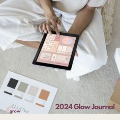 a woman sitting on the floor holding an ipad