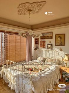 a bed sitting in a bedroom next to a window with blinds on top of it