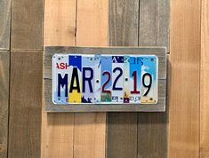 a license plate mounted to the side of a wooden wall