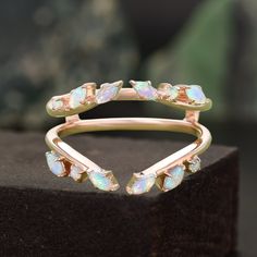 a gold ring with opal stones on it