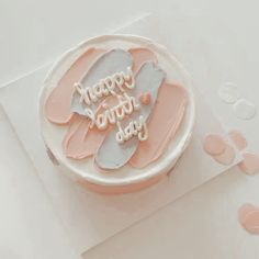 a birthday cake with pink frosting and white icing