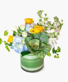 an arrangement of flowers in a green vase