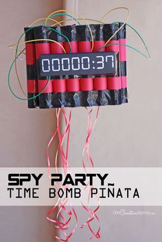 a party time bomb pinata hanging from a string with the words spy party time bomb pinata on it