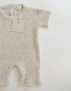 This beautiful soft knit playsuit is a capsule wardrobe staple. Another beautiful sprinkle knit favorite. It’s made of soft premium cotton, perfect for making those little ones comfortable for all kinds of play! Easy to wear over and over again and easy to clean. Designed with 2 back buttons for simple on and off. This playsuit is ready for lots of lounging and snuggling! Beige Cotton Onesie For Spring, Casual Cream Onesie For Playwear, Cozy Cotton Jumpsuits And Rompers For Loungewear, Ribbed Cotton Onesie For Loungewear, Fitted Cotton Bubble Romper For Loungewear, Casual Ribbed Onesie For Loungewear, Casual Fitted Bubble Romper For Loungewear, Casual Cotton Ribbed Onesie, Casual Ribbed Onesie