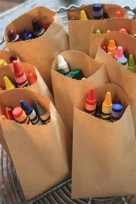 there are many crayons in the paper bags