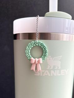 a close up of a cup with a chain on the handle and a keychain attached to it