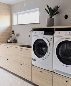 the washer and dryer are sitting in front of each other on the counter