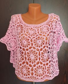 a pink crocheted top on a mannequin