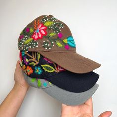 three hats are stacked on top of each other in the shape of a flowered hat