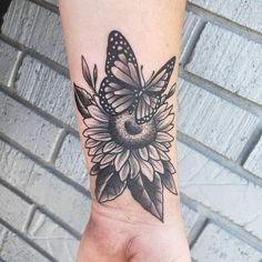 a woman's arm with a butterfly tattoo on it