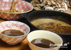 three bowls filled with food sitting on top of a wooden table next to other dishes