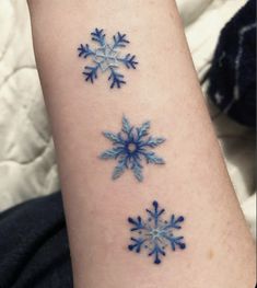 three blue snowflakes on the arm