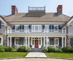 a large house with blue shutters and white trim