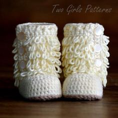 a pair of crocheted baby booties with buttons on the front and bottom