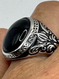 This is a Persian-styled vintage onyx mens ring set in 925 sterling silver accented with 14k gold and a genuine black onyx. This is a gorgeous ring, intricate detail work on the silver set with a beautiful onyx. We have in a sizes 9, 10 11 or 12 this can be sized to your specification, please message us to discuss sizing your ring there is a $20 fee. or engraving options. All of our jewelry is hand polished and shipped to you in a stylish gift box.  We are happy to gift wrap for you.  It is impo Antique Black Jewelry Stamped 925, Formal Black Engraved Ring With Polished Finish, Black Engraved Ring With Polished Finish For Formal Occasions, Luxury Black Engraved Ring With Polished Finish, Formal Onyx Rings Stamped 925, Classic Black Onyx Signet Ring, Black Cabochon Signet Ring For Formal Occasions, Formal Black Cabochon Signet Ring, Classic Black Engraved Ring With Black Enamel