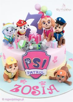 a birthday cake with paw patrol figurines on it