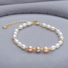 This beautiful Freshwater pearl bracelet ranges between 7-8mm in size and consists of beautiful and lustrous pearls in AAAA+ quality. All pearls in this bracelet are round and are strung with silk thread and double-knotted between each pearl. Known as the 'icon' of cultured pearls, Freshwater pearls have graced the necks, ears, fingers, and wrists of women for decades. Huge Tomato imports their Freshwater pearls from the Freshwater rs of Japan, grown in the Pinctada fucata oyster. All of our Fre Gold Pearl Bracelet, Pearl Bracelet Gold, Cultured Pearl Bracelet, Jewerly Designs, Buy Pearls, Freshwater Pearl Jewelry, Freshwater Pearl Bracelet, Pearl Types, Silk Thread