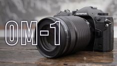 a camera sitting on top of a wooden table next to the words, canon 1