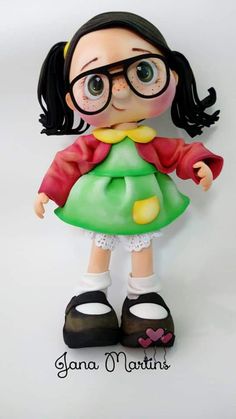 a doll with glasses and a green dress