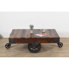 a coffee table with wheels on the bottom