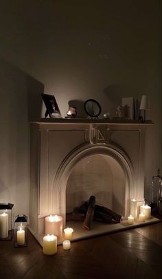 a fireplace with lit candles in front of it