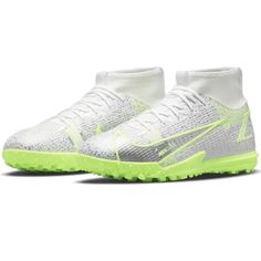 a pair of white shoes with neon green soles on the bottom and upper part of the shoe